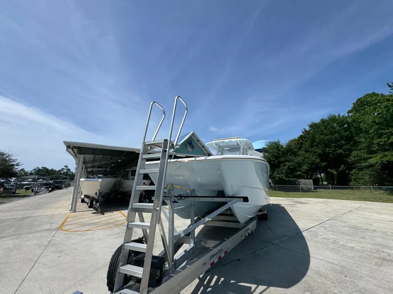 Slide: The Image of 2026 Invincible 38 Catamaran on trailer under clear blue sky. - 5