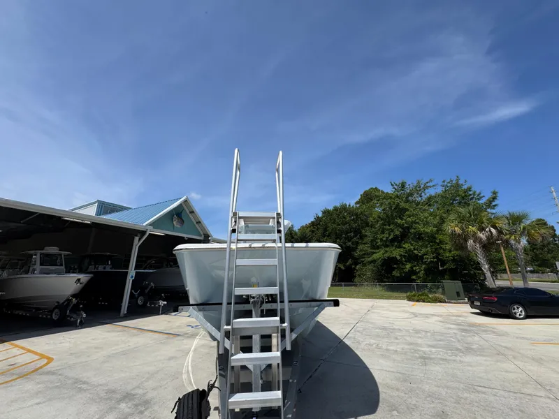 Slide: The Image of 2026 Invincible 38 Catamaran on trailer under clear blue sky. - 6