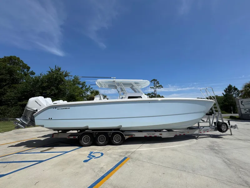 Slide: The Image of 2026 Invincible 38 Catamaran on trailer under clear blue sky. - 9