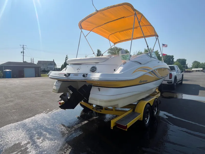 Slide: The Image of 2013 Hurricane SunDeck 2200 DC IO boat with yellow canopy on trailer. - 3