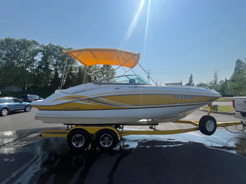 Slide: The Image of 2013 Hurricane SunDeck 2200 DC IO boat with yellow canopy on trailer. - 4