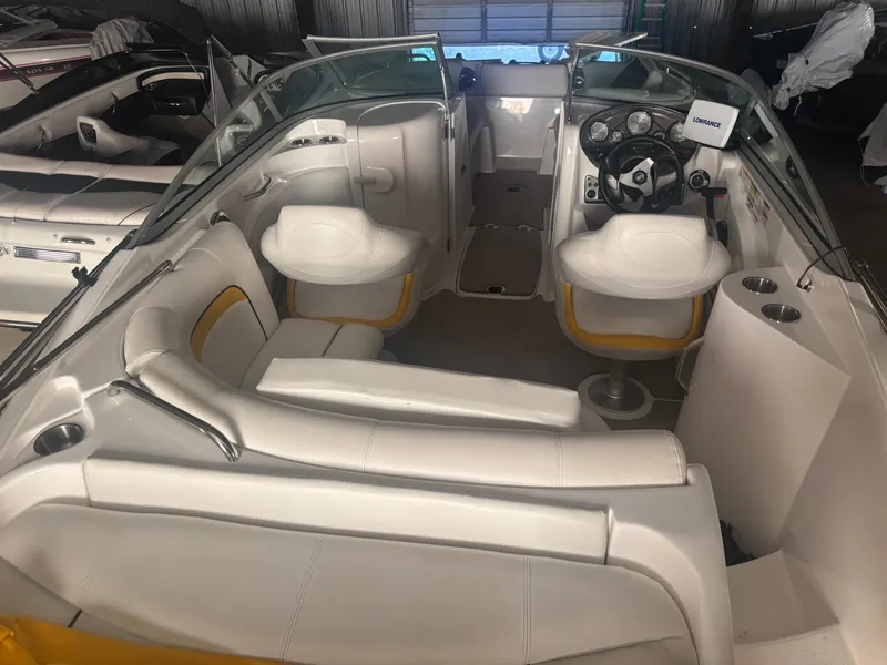 Slide: The Image of 2013 Hurricane SunDeck 2200 DC IO boat interior with white seating and steering console. - 6