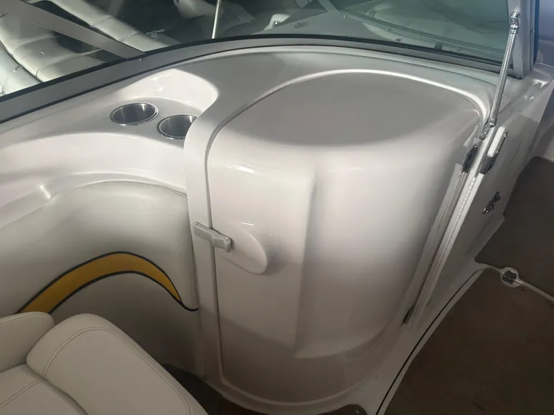 Slide: The Image of 2013 Hurricane SunDeck 2200 DC IO boat interior with cup holders and seating. - 8