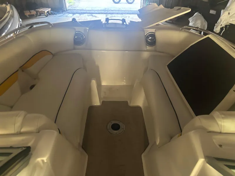 Slide: The Image of 2013 Hurricane SunDeck 2200 DC IO boat interior with white seating and open deck. - 9