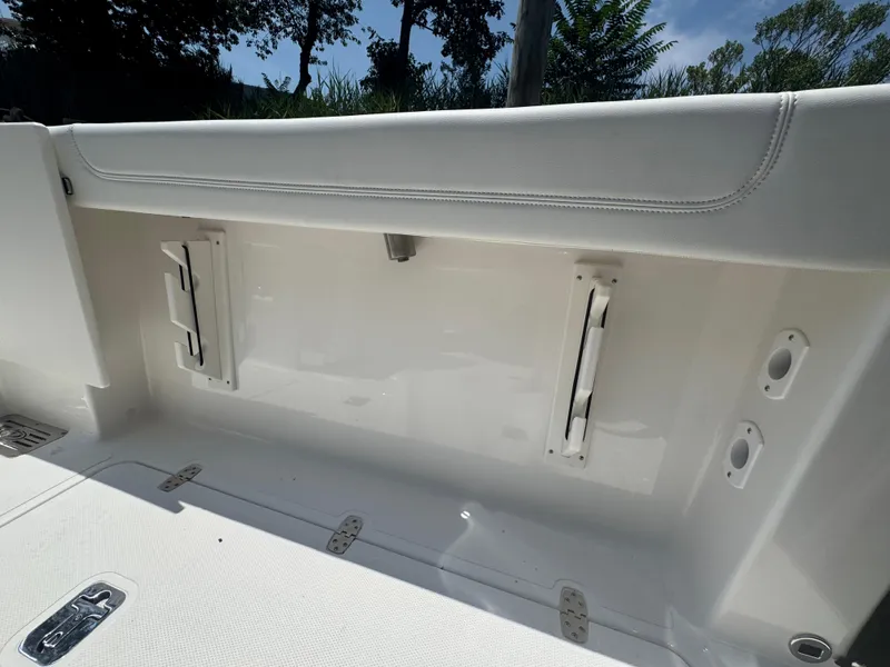 Slide: The Image of 2026 Pursuit DC 306 boat interior detail with white seating and storage compartments. - 11