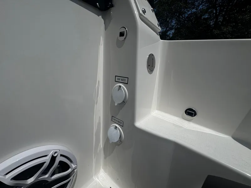 Slide: The Image of 2026 Pursuit DC 306 boat interior showing water access points and speaker. - 12