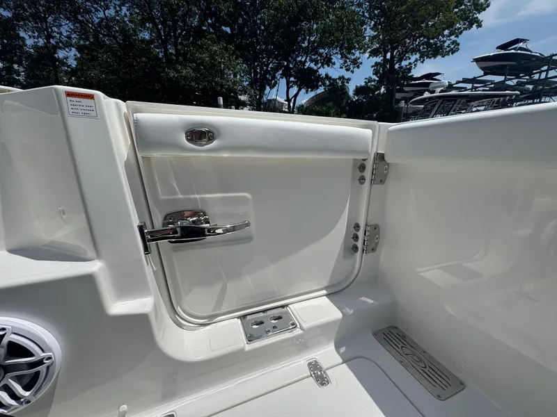 Slide: The Image of 2026 Pursuit DC 306 boat interior with sleek white door and chrome handle. - 13