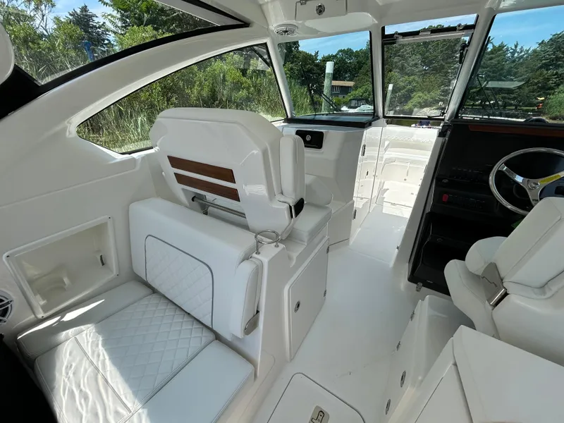 Slide: The Image of Luxurious interior of 2026 Pursuit DC 306 boat with white seating and modern design. - 14