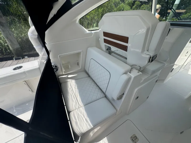 Slide: The Image of 2026 Pursuit DC 306 boat interior with white seating and modern design. - 15