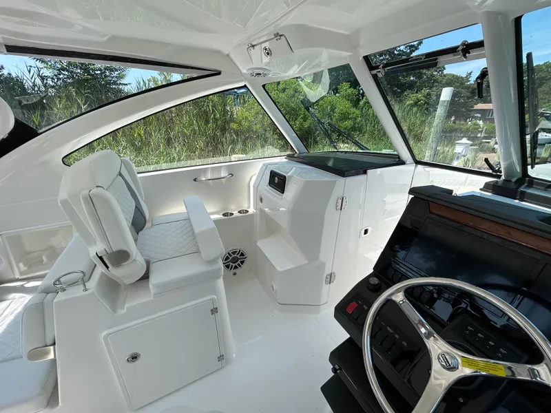 Slide: The Image of Interior of 2026 Pursuit DC 306 boat, featuring modern helm and seating. - 20