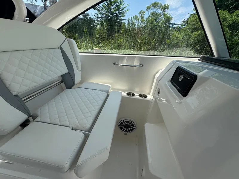 Slide: The Image of Luxurious interior of 2026 Pursuit DC 306 boat with white quilted seating. - 24