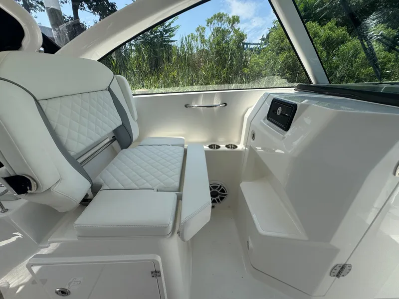 Slide: The Image of 2026 Pursuit DC 306 boat interior with white seating and modern design. - 25