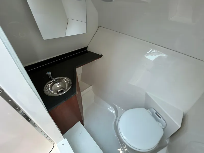 Slide: The Image of Compact bathroom in 2026 Pursuit DC 306 boat with sink and toilet. - 27