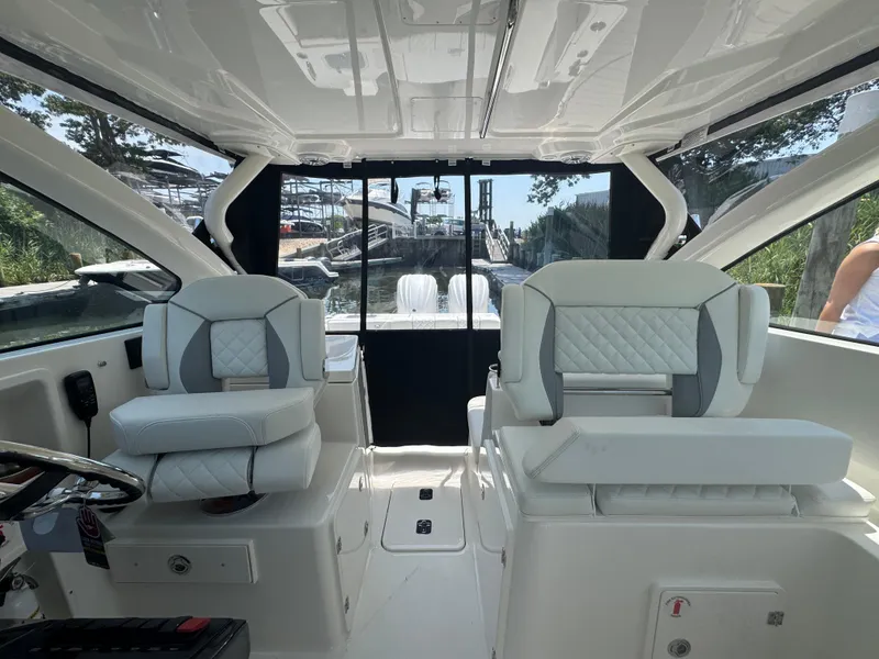 Slide: The Image of Interior of 2026 Pursuit DC 306 boat with luxurious seating and modern design. - 29