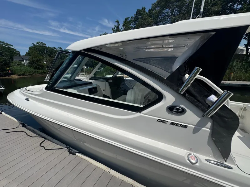 Slide: The Image of 2026 Pursuit DC 306 boat docked, showcasing sleek design and modern features. - 3