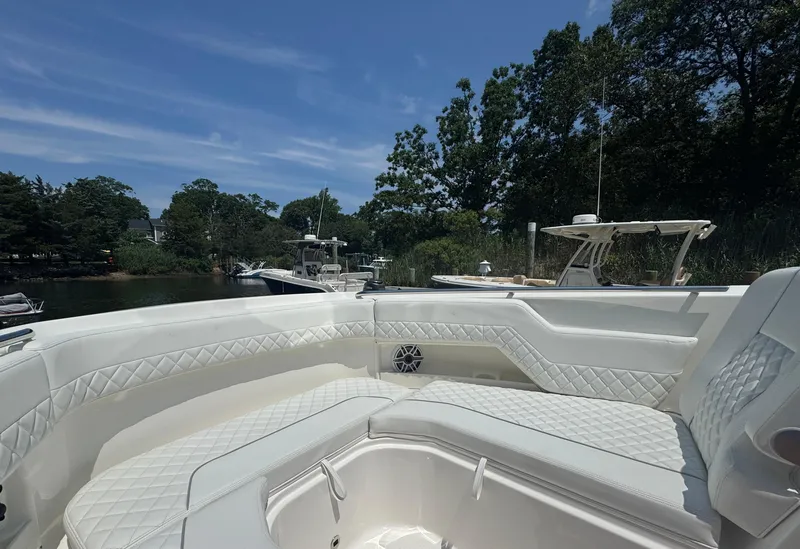 Slide: The Image of Luxurious interior of 2026 Pursuit DC 306 boat with white quilted seating. - 35