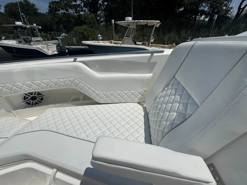 Slide: The Image of Luxurious white seating on 2026 Pursuit DC 306 boat, featuring diamond stitching and armrest. - 36