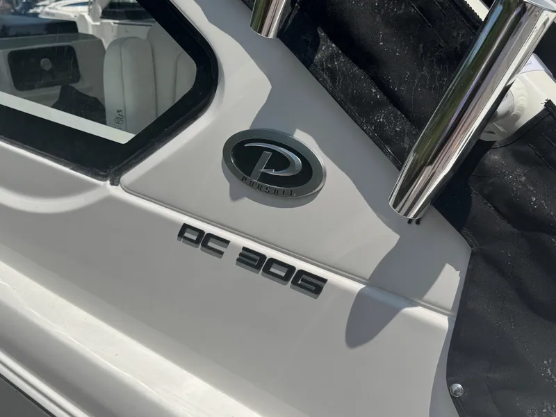Slide: The Image of 2026 Pursuit DC 306 boat emblem and model name on white surface. - 4