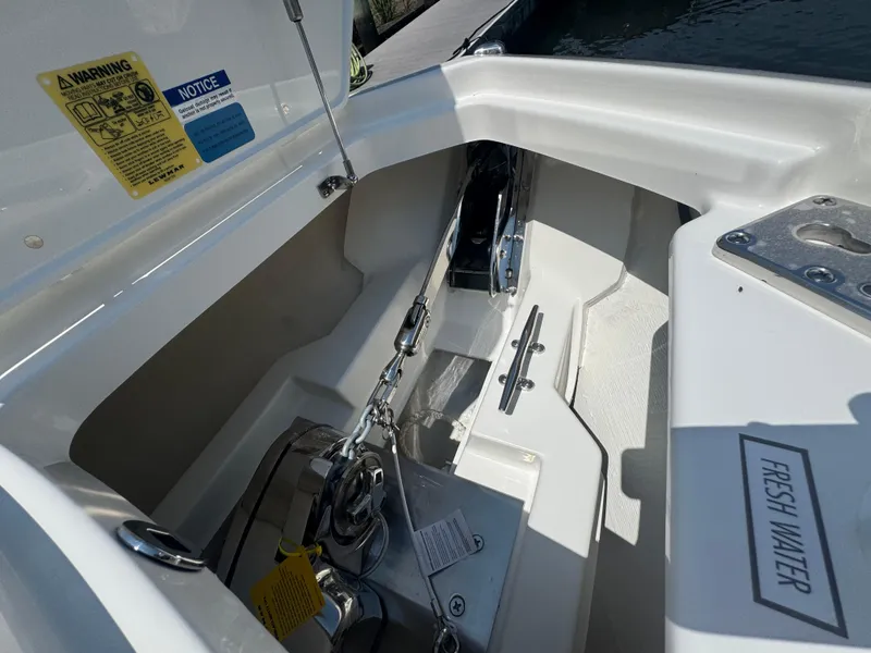 Slide: The Image of Anchor compartment of 2026 Pursuit DC 306 boat with fresh water access. - 41