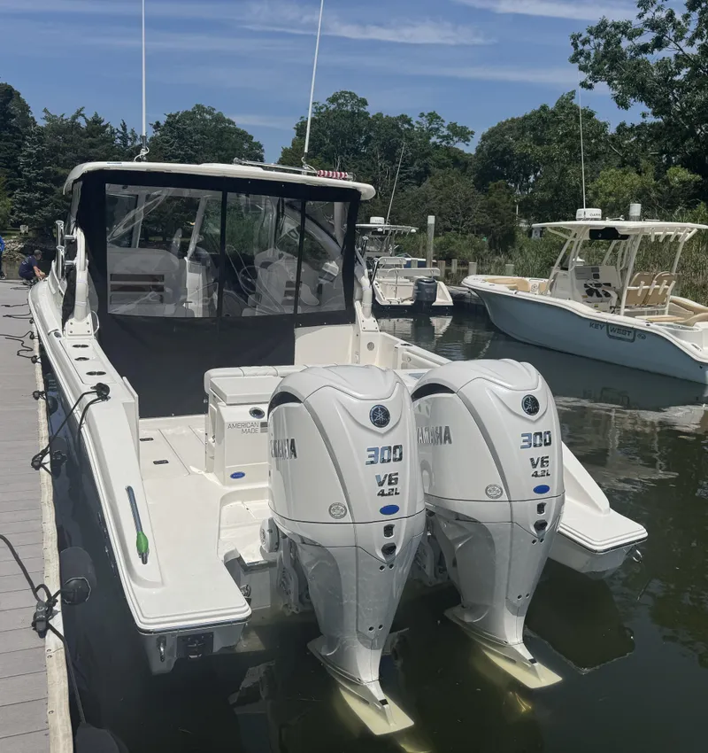 Slide: The Image of 2026 Pursuit DC 306 boat with twin Yamaha 300 V6 engines docked in a marina. - 5