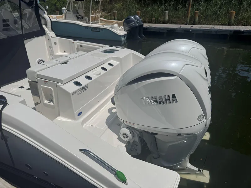Slide: The Image of 2026 Pursuit DC 306 boat with Yamaha outboard engines, docked in a marina. - 6