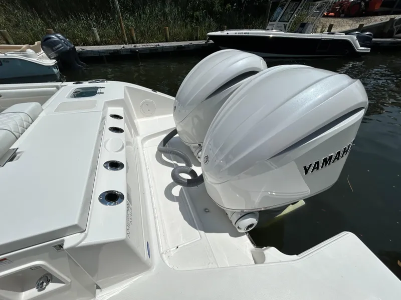 Slide: The Image of 2026 Pursuit DC 306 boat with dual Yamaha outboard engines docked by the water. - 7