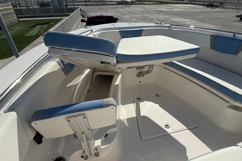 Slide: The Image of 2025 Robalo R300 Center Console boat interior with seating and storage compartments. - 14