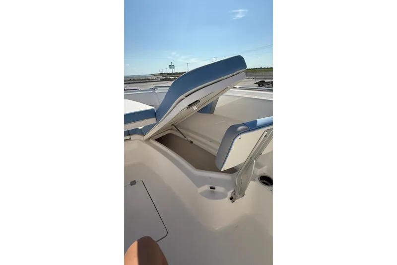 Slide: The Image of 2025 Robalo R300 Center Console boat with open storage compartment under seating. - 15