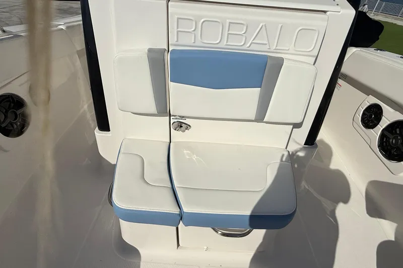 Slide: The Image of 2025 Robalo R300 Center Console boat seat with blue and white upholstery. - 16