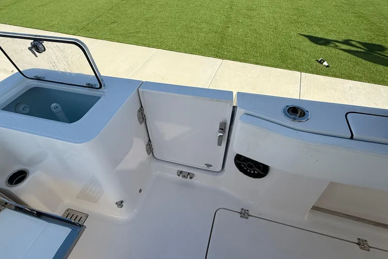Slide: The Image of 2025 Robalo R300 Center Console boat interior with storage and seating features. - 17
