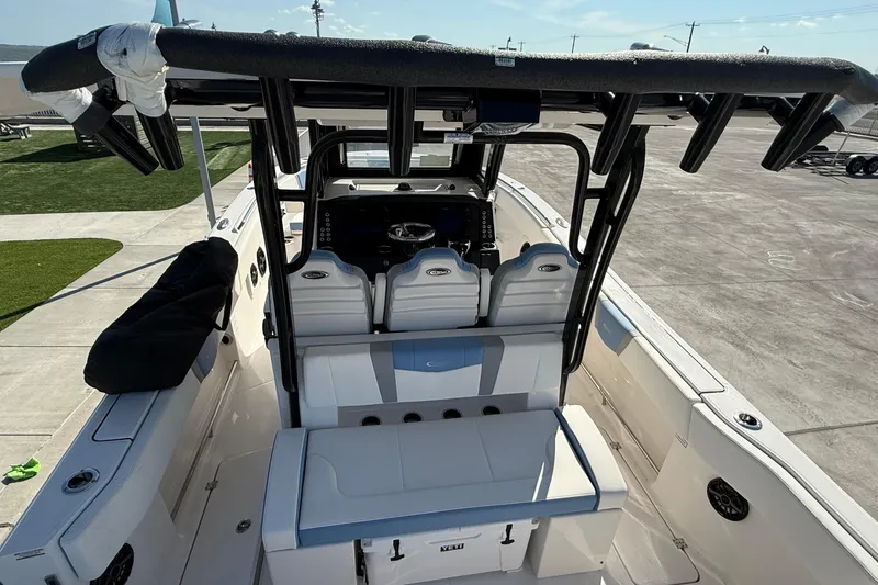 Slide: The Image of 2025 Robalo R300 Center Console boat interior with seating and console view. - 18