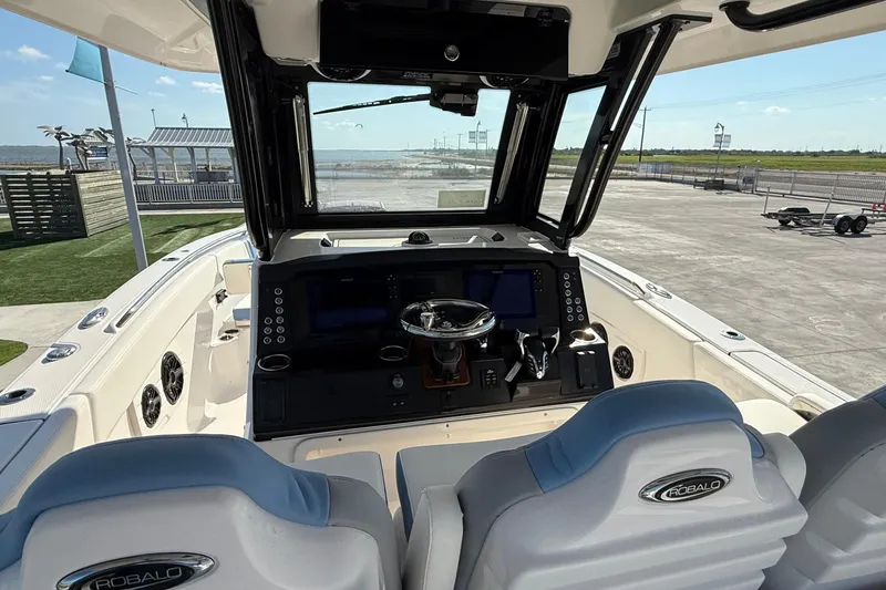 Slide: The Image of 2025 Robalo R300 Center Console boat interior with modern dashboard and dual seating. - 19