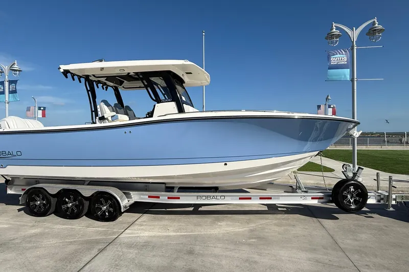 Slide: The Image of 2025 Robalo R300 Center Console boat on trailer, displayed outdoors. - 7