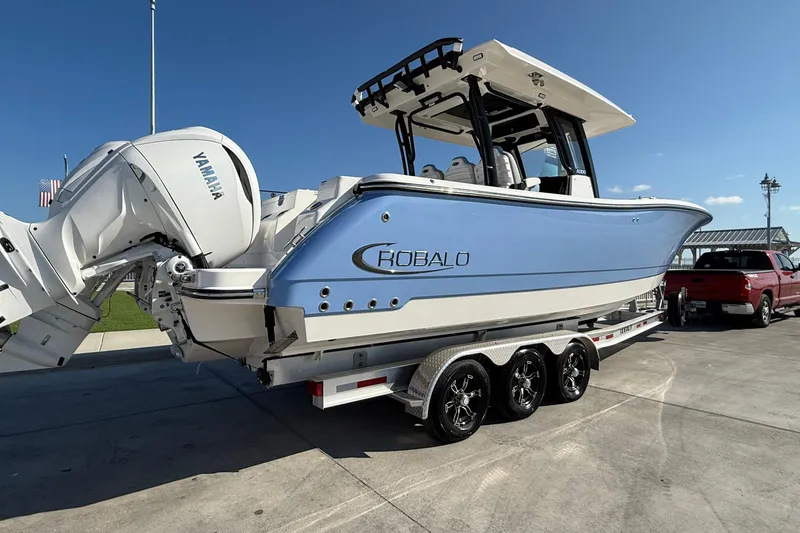 Slide: The Image of 2025 Robalo R300 Center Console boat on trailer with Yamaha engines. - 9