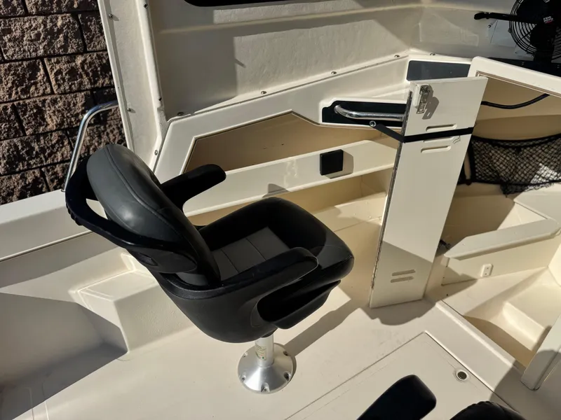 Slide: The Image of Interior of 2020 Arima Sea Chaser 19 Yellowtail Edition boat with black captain's chair. - 11