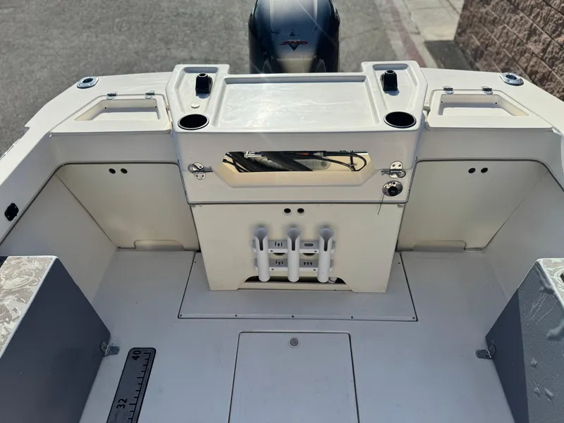 Slide: The Image of 2020 Arima Sea Chaser 19 Yellowtail Edition boat interior with storage compartments and rod holders. - 14