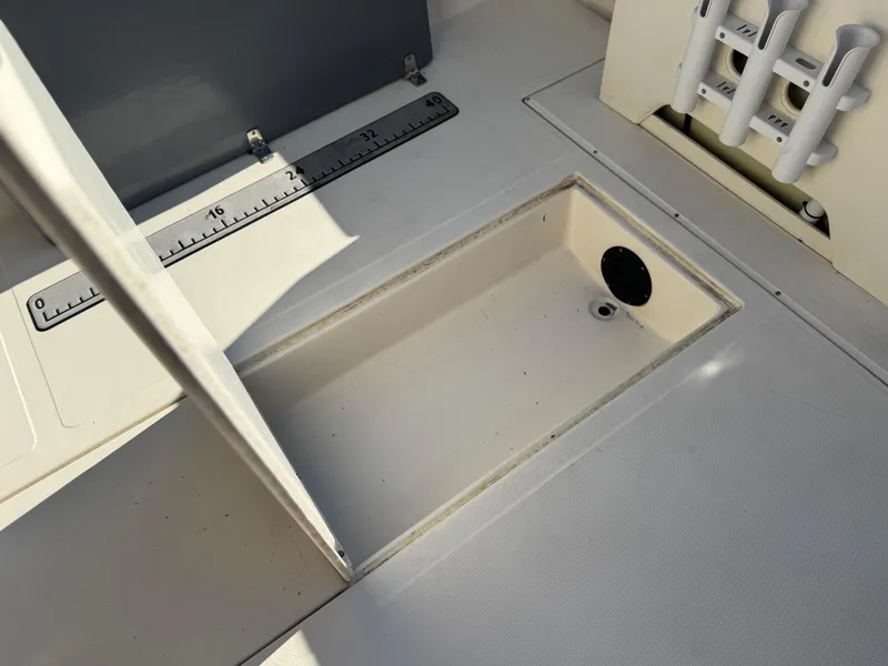 Slide: The Image of 2020 Arima Sea Chaser 19 Yellowtail Edition boat deck with storage compartment and rod holders. - 17