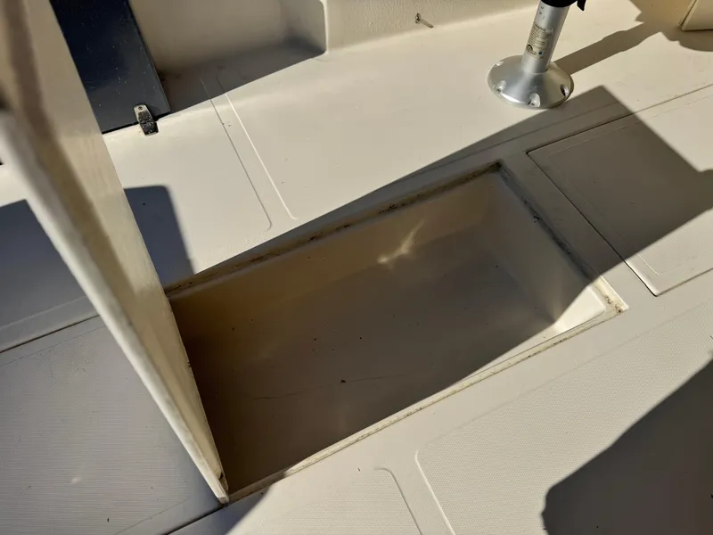 Slide: The Image of 2020 Arima Sea Chaser 19 Yellowtail Edition boat deck with open storage compartment. - 18