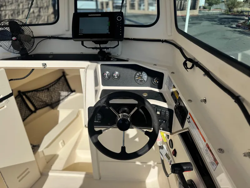 Slide: The Image of Interior of 2020 Arima Sea Chaser 19 Yellowtail Edition boat with steering wheel and controls. - 20