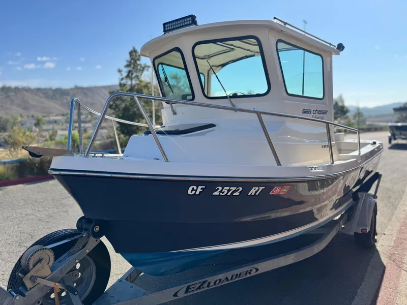Slide: The Image of 2020 Arima Sea Chaser 19 Yellowtail Edition boat on trailer, parked outdoors. - 3