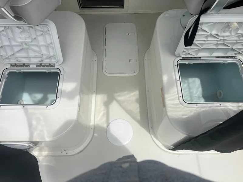 Slide: The Image of 2021 Parker 2510 XL Walkaround boat interior with open storage compartments. - 11