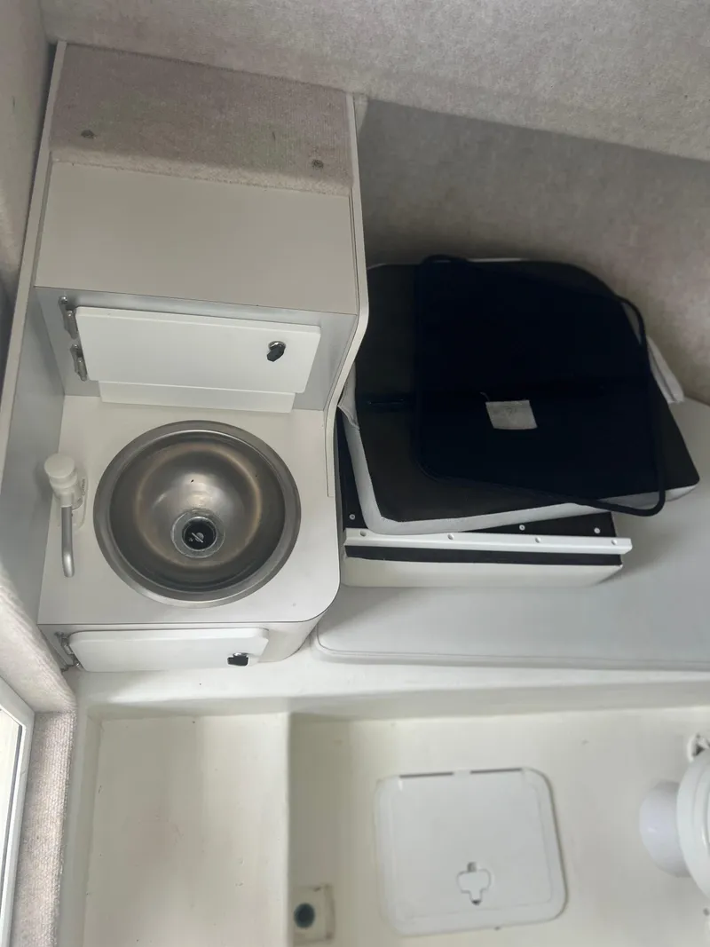 Slide: The Image of Interior of 2021 Parker 2510 XL Walkaround boat with sink and storage. - 12