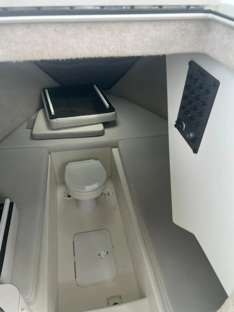 Slide: The Image of Interior cabin of 2021 Parker 2510 XL Walkaround boat with toilet and control panel. - 13