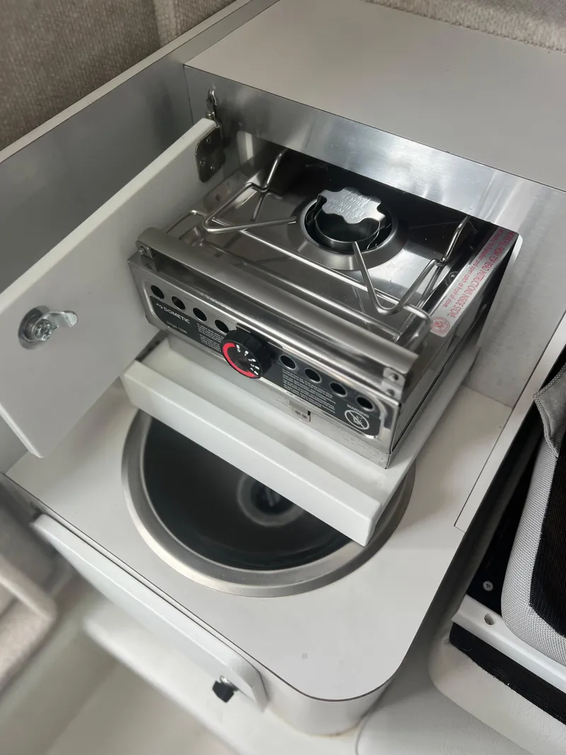 Slide: The Image of Compact kitchen setup in 2021 Parker 2510 XL Walkaround boat with stove and sink. - 14