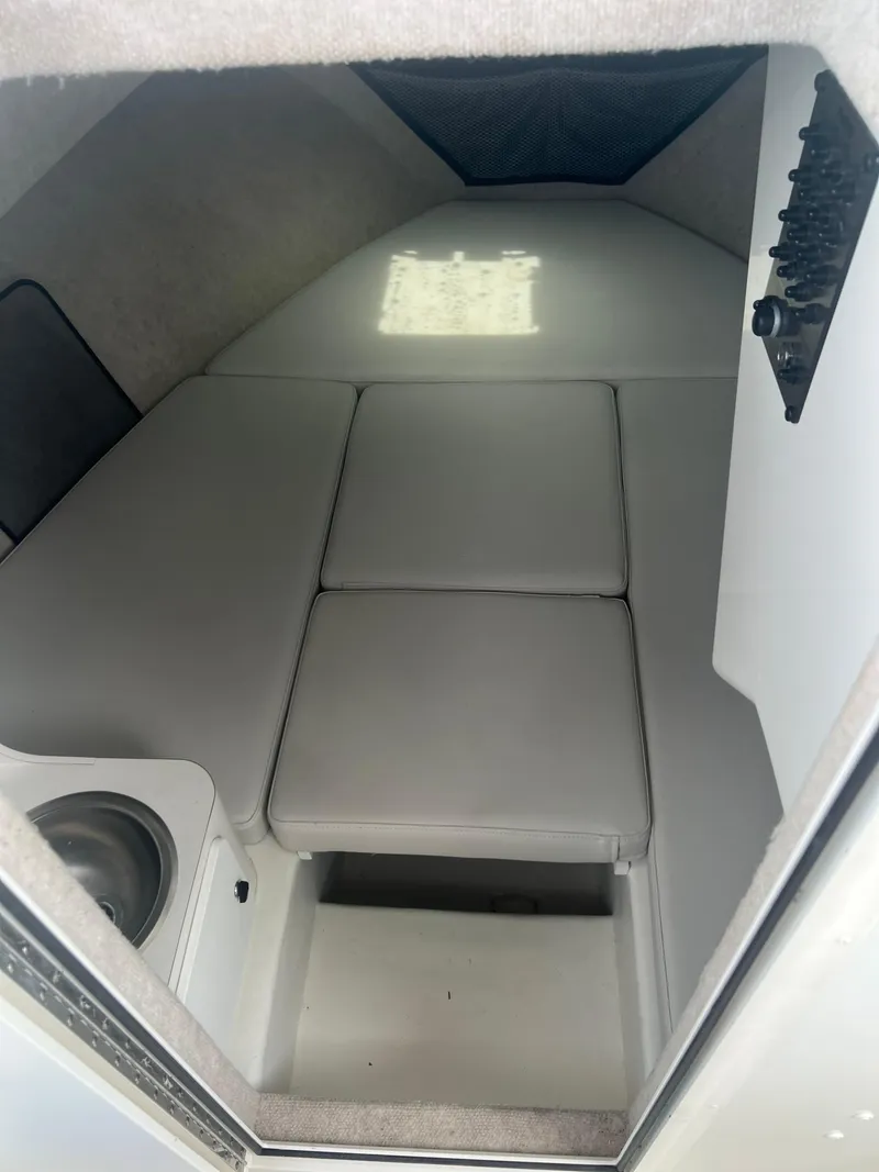 Slide: The Image of 2021 Parker 2510 XL Walkaround cabin interior with cushioned seating and compact sink. - 15