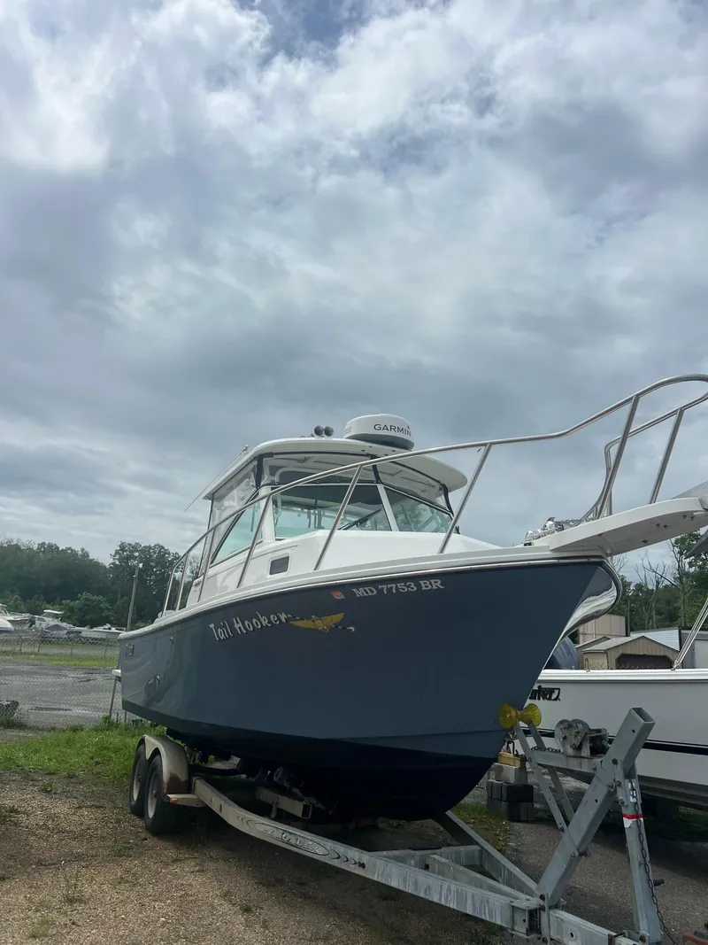 Slide: The Image of 2021 Parker 2510 XL Walkaround boat on trailer under cloudy sky. - 3