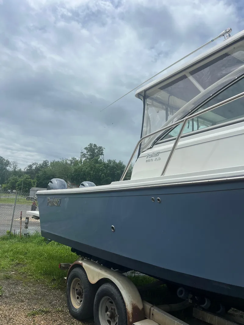 Slide: The Image of 2021 Parker 2510 XL Walkaround boat on trailer under cloudy sky. - 4