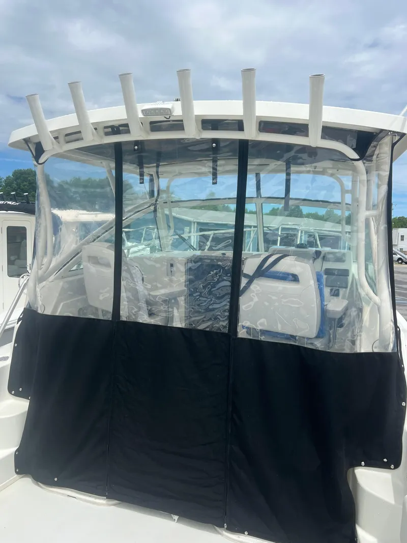 Slide: The Image of 2021 Parker 2510 XL Walkaround boat with covered cockpit and rod holders. - 9