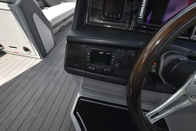 Slide: The Image of 2023 Bentley Pontoons 250 Elite Swingback Dual Captain dashboard with steering wheel and controls. - 10