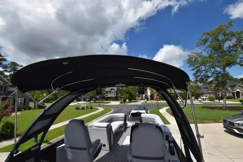 Slide: The Image of 2023 Bentley Pontoons 250 Elite Swingback Dual Captain on a sunny suburban street. - 13